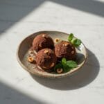 Delicious hazelnut chocolate truffles on a white marble table