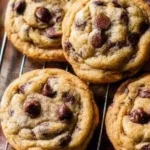 Freshly baked chocolate chip cookies on a cooling rack