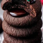 Delicious Chocolate Thumbprint Cookies topped with chocolate filling and sprinkles.