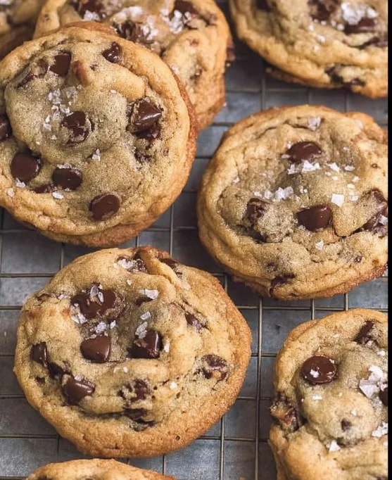 Crispy and chewy chocolate chip cookies on a cooling rack