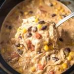 Bowl of creamy Crockpot White Chicken Chili topped with cilantro and jalapeños