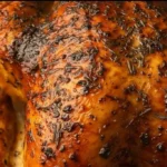 plated easy roast turkey garnished with herbs and vegetables