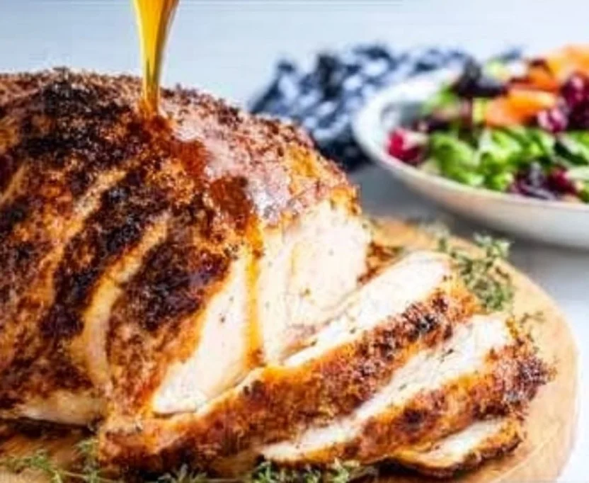 Garlic Butter Boneless Turkey Breast served on a platter with herbs.