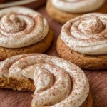 Soft pumpkin cookies with cinnamon frosting on a white plate