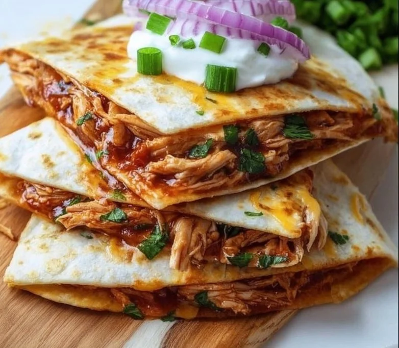 Delicious BBQ Chicken Quesadillas served with dipping sauce and fresh toppings.