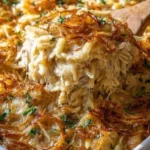 Delicious French onion chicken orzo casserole topped with melted cheese.